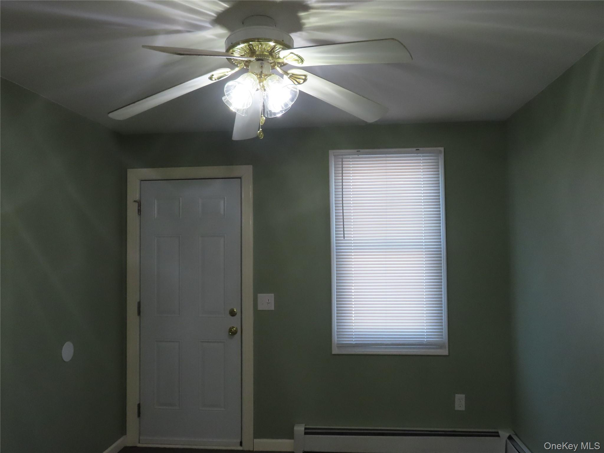 44 Terry Street Patchogue, NY 11772 - Photo 7 of 15 a view of a livingroom with a chandelier fan and a window