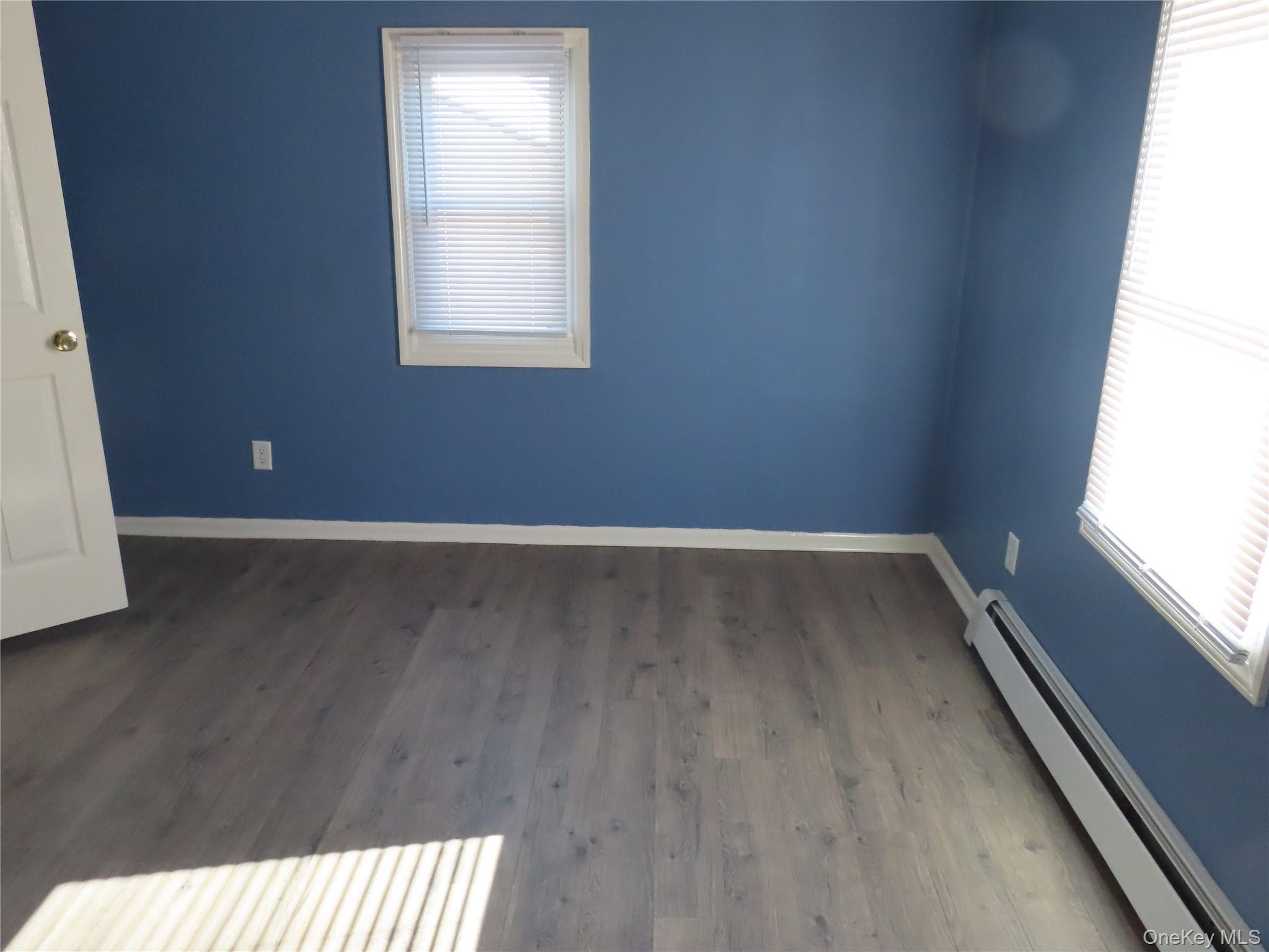 44 Terry Street Patchogue, NY 11772 - Photo 10 of 15 an empty room with wooden floor and windows