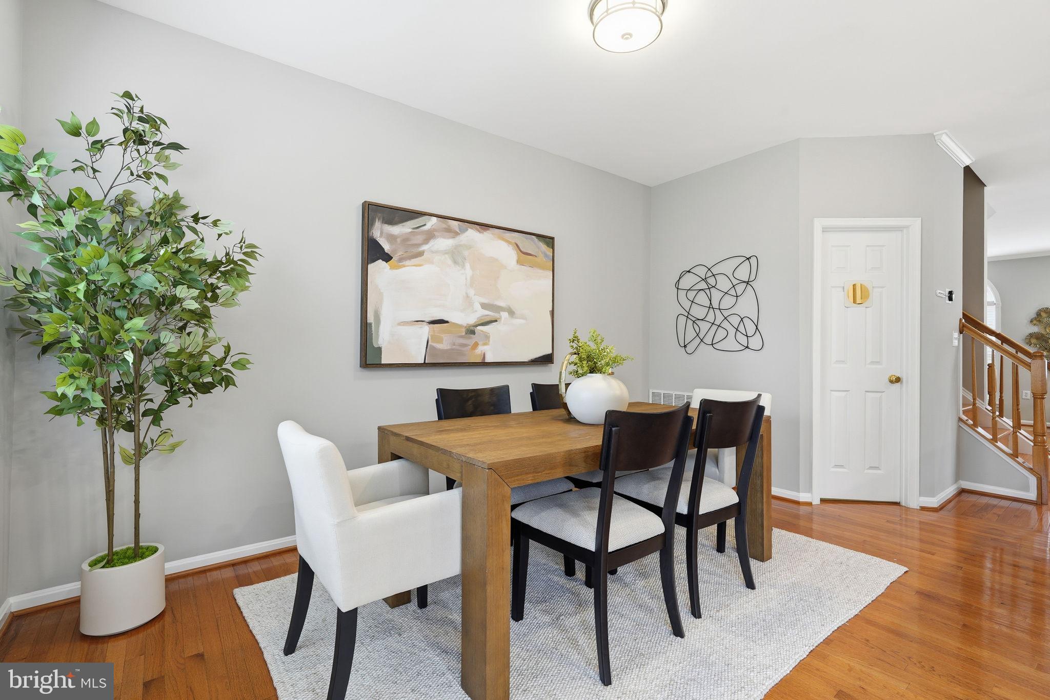 46600 Chase View Terrace Sterling, VA 20164 - Photo 12 of 38 a view of a dining room with furniture and wooden floor