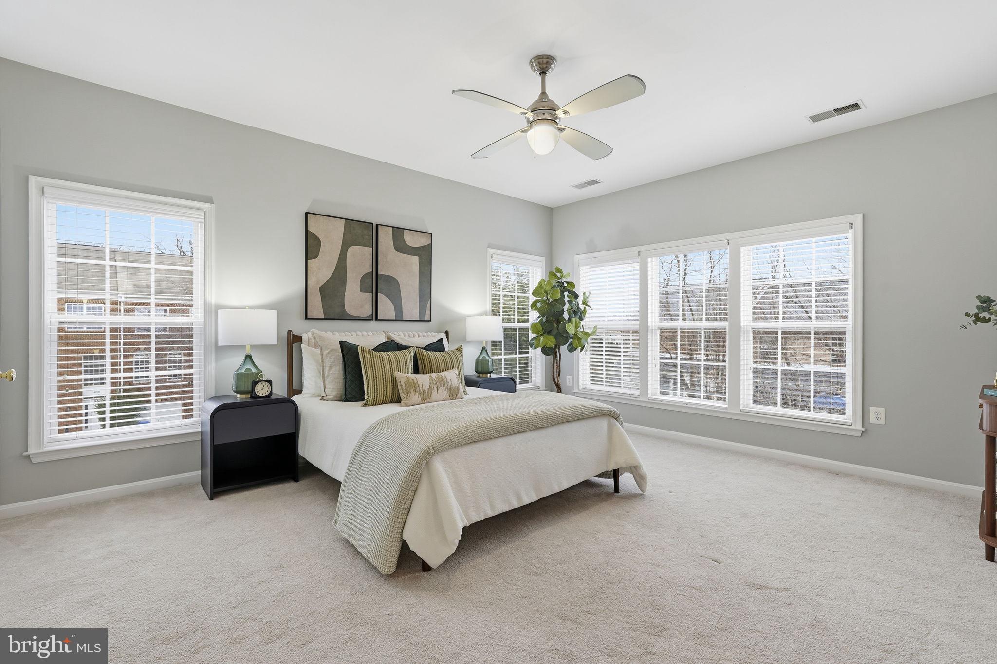 46600 Chase View Terrace Sterling, VA 20164 - Photo 16 of 38 a spacious bedroom with a bed a couch and large window