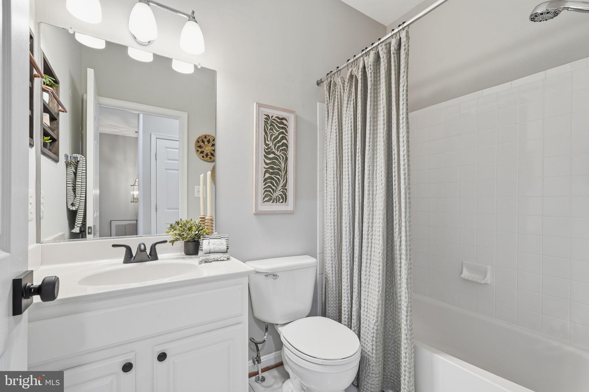 46600 Chase View Terrace Sterling, VA 20164 - Photo 25 of 38 a bathroom with a sink a toilet a mirror and shower