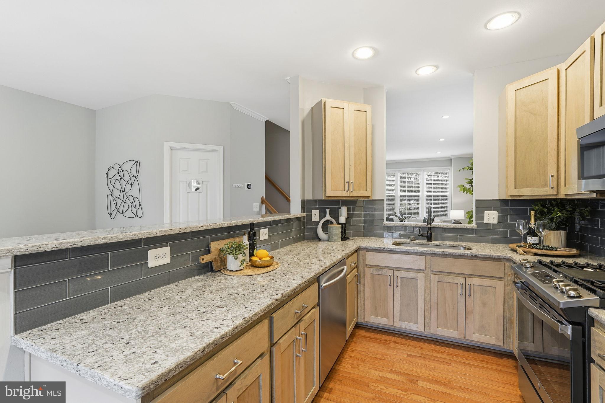 46600 Chase View Terrace Sterling, VA 20164 - Photo 8 of 38 a kitchen with a sink stove and cabinets