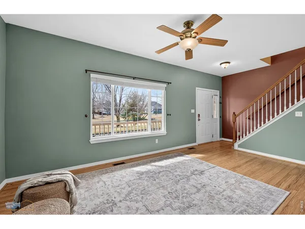 a view of a livingroom with a ceiling fan and window