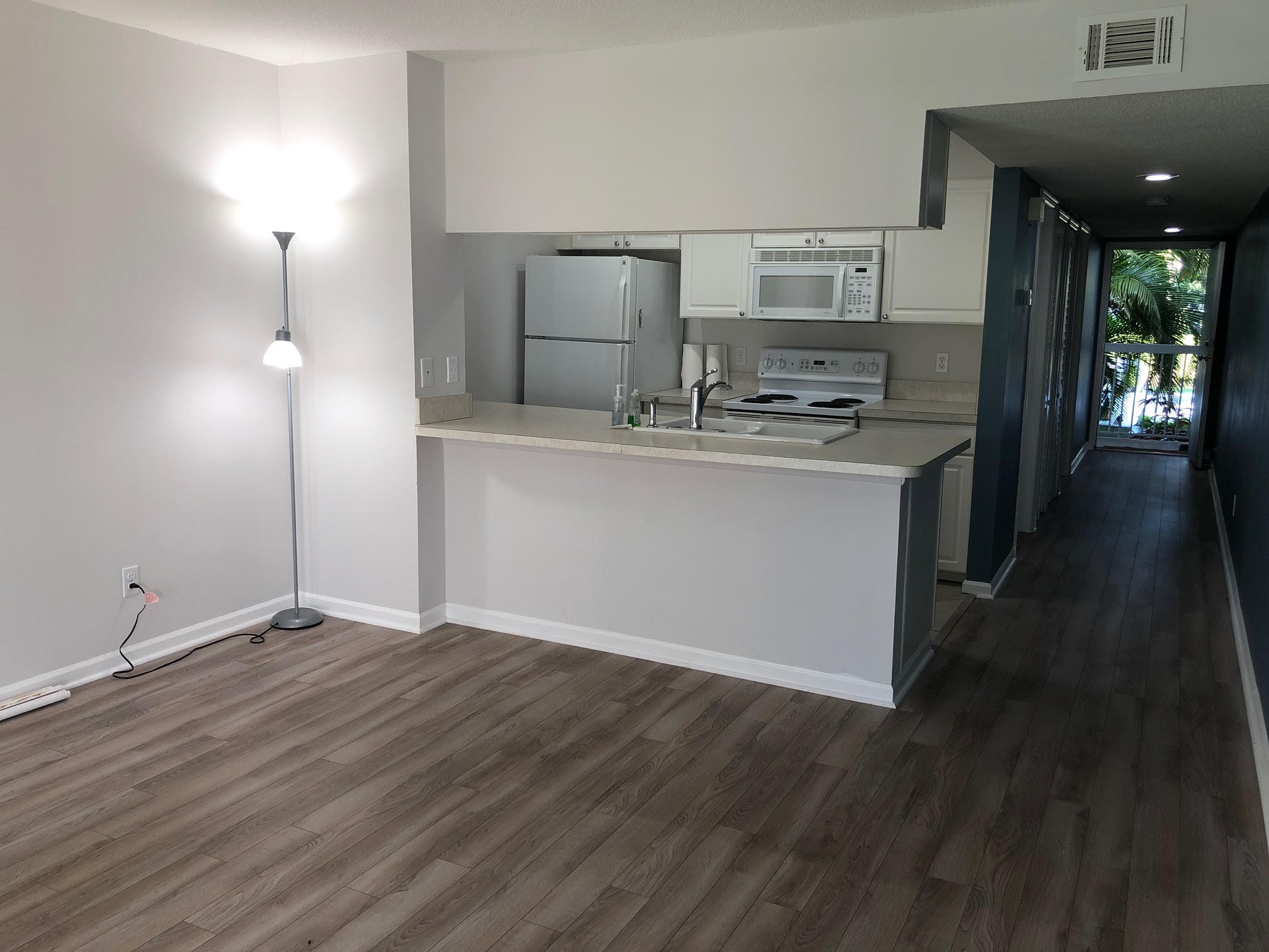 a view of open kitchen with granite countertop cabinets and wooden floor