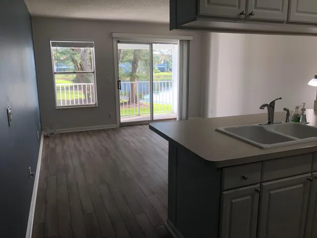 a kitchen with a wooden floor and a window