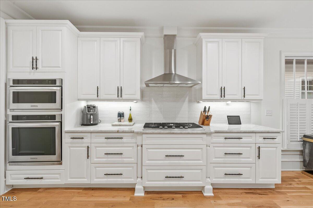 2926 Barmettler Street Raleigh, NC 27607 - Photo 14 of 74 a kitchen with granite countertop white cabinets and stainless steel appliances