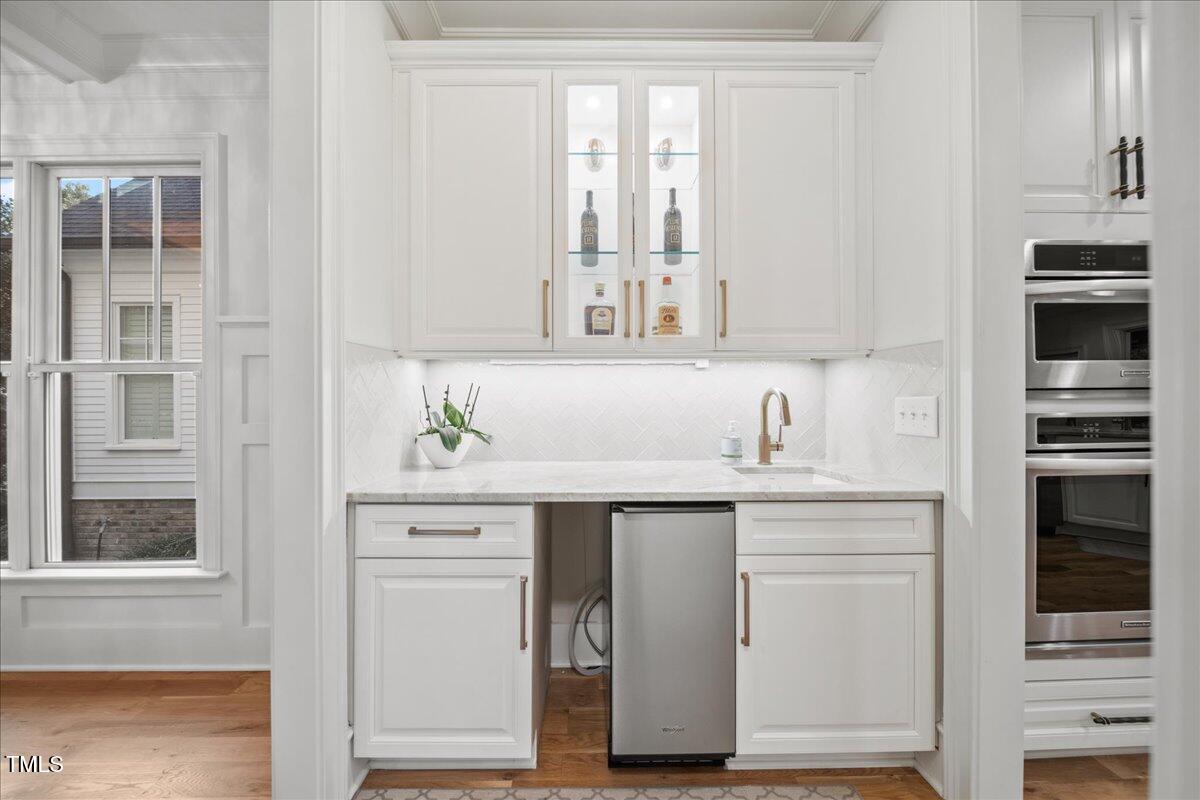 2926 Barmettler Street Raleigh, NC 27607 - Photo 15 of 74 a kitchen with cabinets appliances and a window