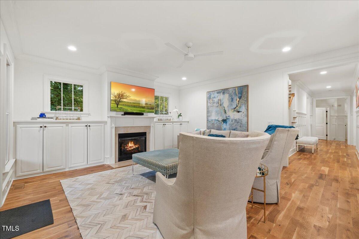 2926 Barmettler Street Raleigh, NC 27607 - Photo 29 of 74 a living room with furniture a fireplace and a flat screen tv