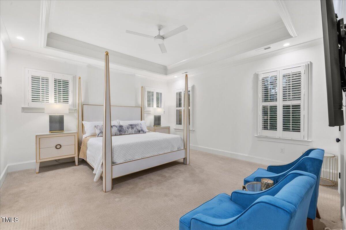 2926 Barmettler Street Raleigh, NC 27607 - Photo 36 of 74 a spacious bedroom with a bed and a couch