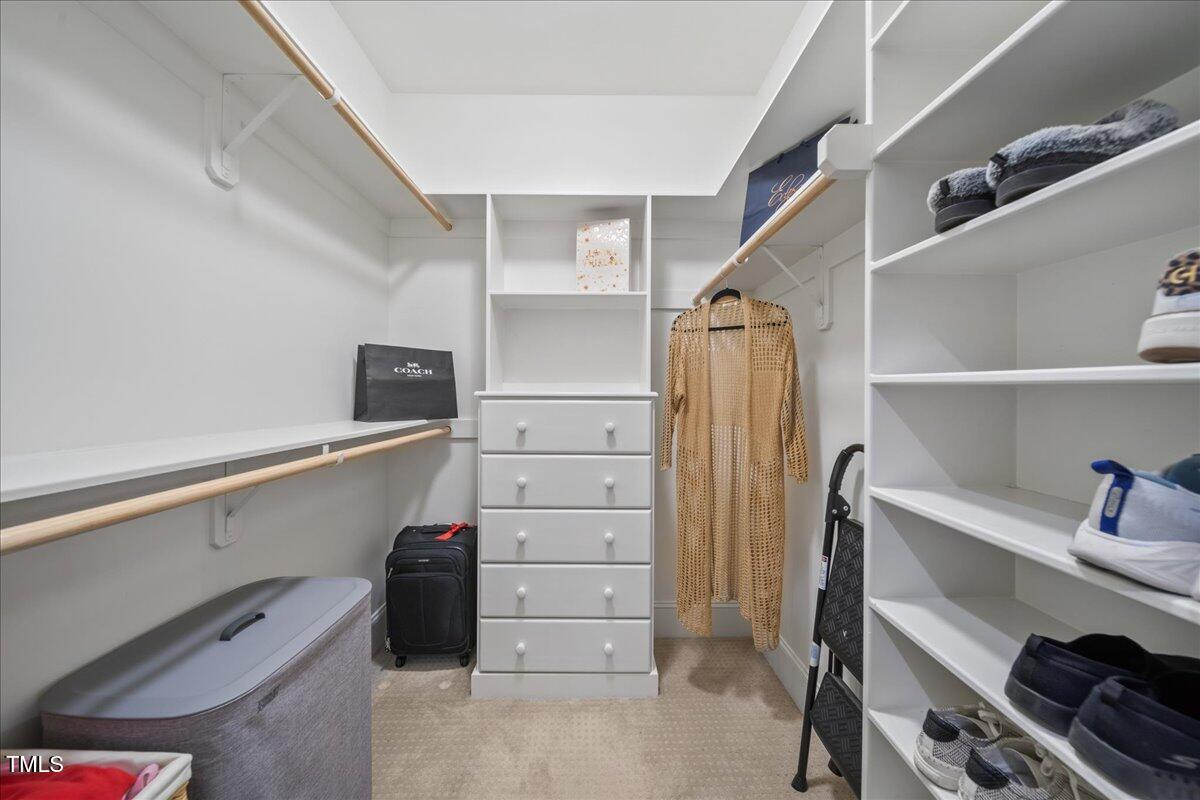 2926 Barmettler Street Raleigh, NC 27607 - Photo 39 of 74 a view of walk in closet with clothes and shoes