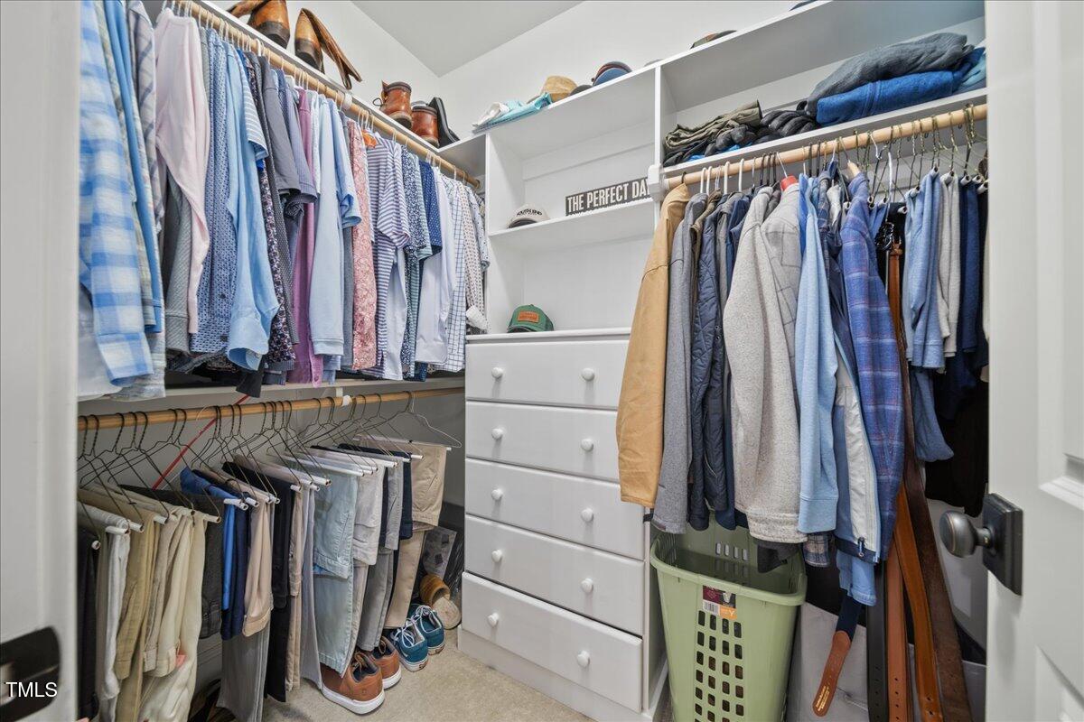 2926 Barmettler Street Raleigh, NC 27607 - Photo 42 of 74 a view of walk in closet with clothes