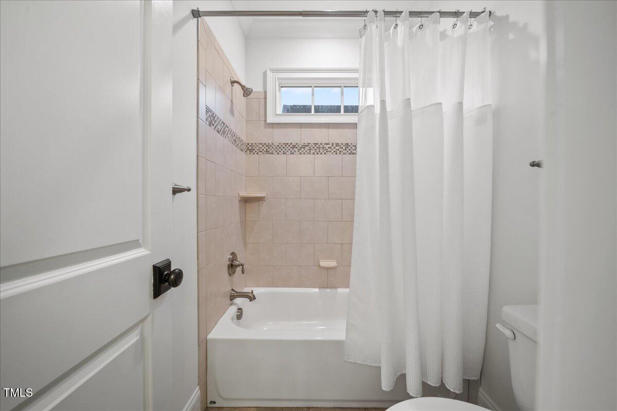 2926 Barmettler Street Raleigh, NC 27607 - Photo 48 of 74 a bathroom with a bathtub a shower and a sink