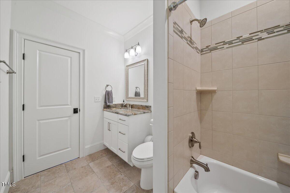 2926 Barmettler Street Raleigh, NC 27607 - Photo 55 of 74 a bathroom with a granite countertop toilet a sink and a bathtub