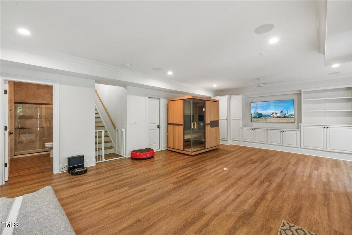 2926 Barmettler Street Raleigh, NC 27607 - Photo 60 of 74 a view of a room with wooden floor and stairs