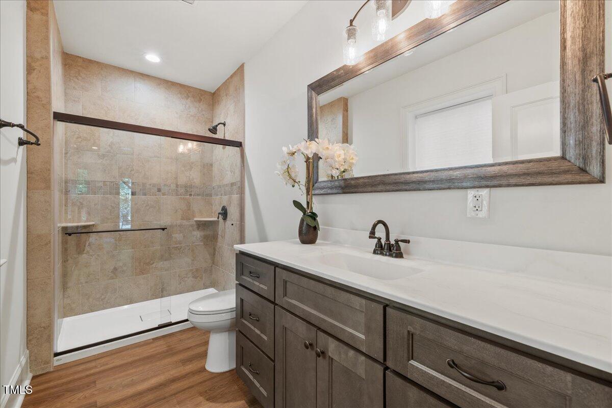 2926 Barmettler Street Raleigh, NC 27607 - Photo 61 of 74 a bathroom with a sink a toilet and shower