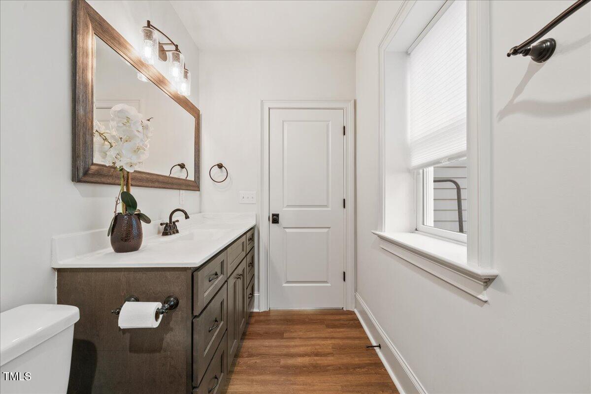 2926 Barmettler Street Raleigh, NC 27607 - Photo 62 of 74 a bathroom with a sink a toilet and a mirror