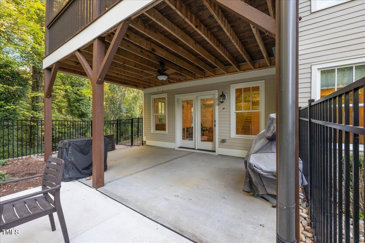 2926 Barmettler Street Raleigh, NC 27607 - Photo 63 of 74 a view of a patio with a table and chairs and floor to ceiling window