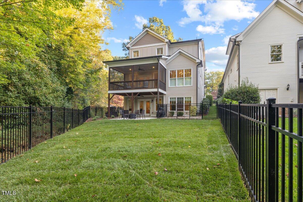 2926 Barmettler Street Raleigh, NC 27607 - Photo 65 of 74 a view of a house with a big yard and large trees