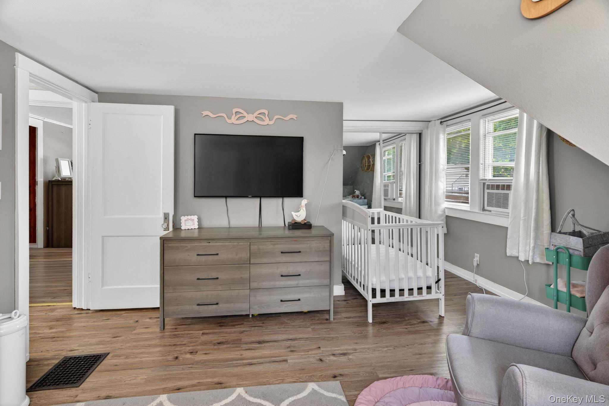 7 Walnut Street Poughkeepsie, NY 12601 - Photo 21 of 30 Combining comfort, functionality, and abundant sunlight, this inviting bedroom creates the perfect place to relax and unwind at the end of the day.