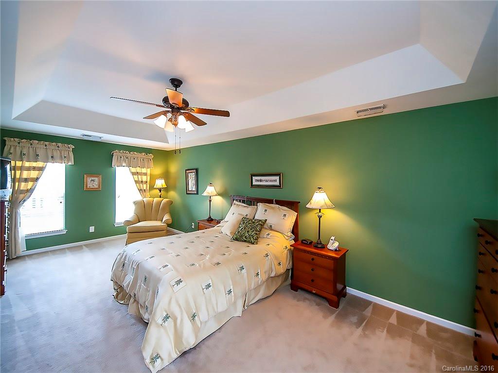 623 Panthers Way Fort Mill, SC 29708 - Photo 14 of 24 a bedroom with a bed and a chandelier