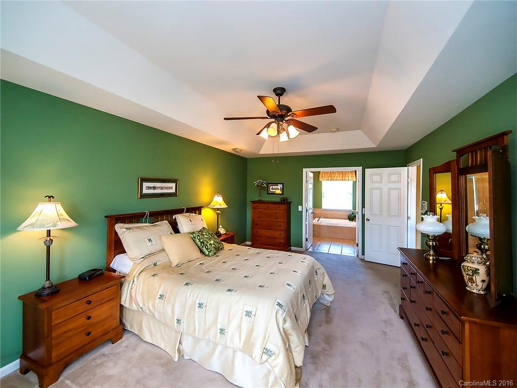 623 Panthers Way Fort Mill, SC 29708 - Photo 15 of 24 a bedroom with a bed chandelier and a flat tv screen