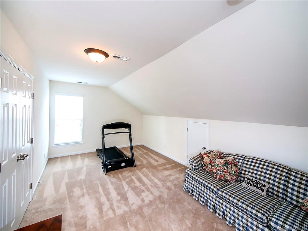 623 Panthers Way Fort Mill, SC 29708 - Photo 20 of 24 a room with a couch and wooden floor