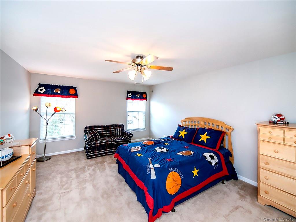 623 Panthers Way Fort Mill, SC 29708 - Photo 21 of 24 a bedroom with a bed and a chandelier