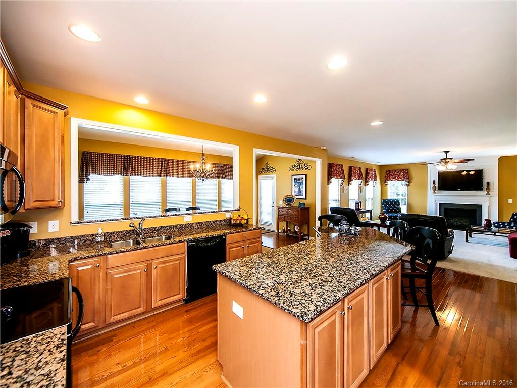 623 Panthers Way Fort Mill, SC 29708 - Photo 6 of 24 a kitchen with kitchen island granite countertop wooden floor and a counter top space