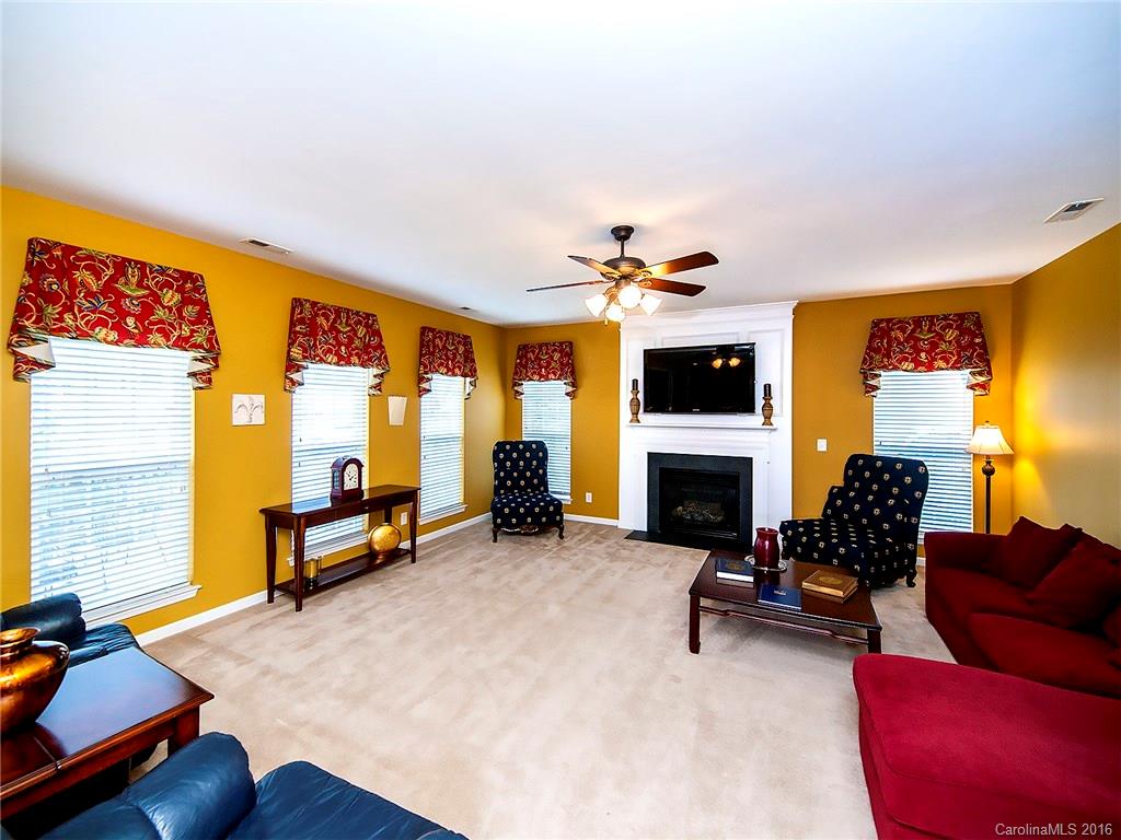 623 Panthers Way Fort Mill, SC 29708 - Photo 10 of 24 a living room with furniture flat screen tv and a fireplace