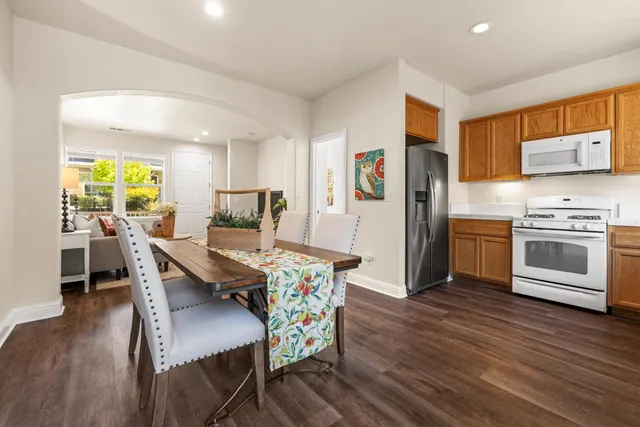 a dining room with furniture and wooden floor