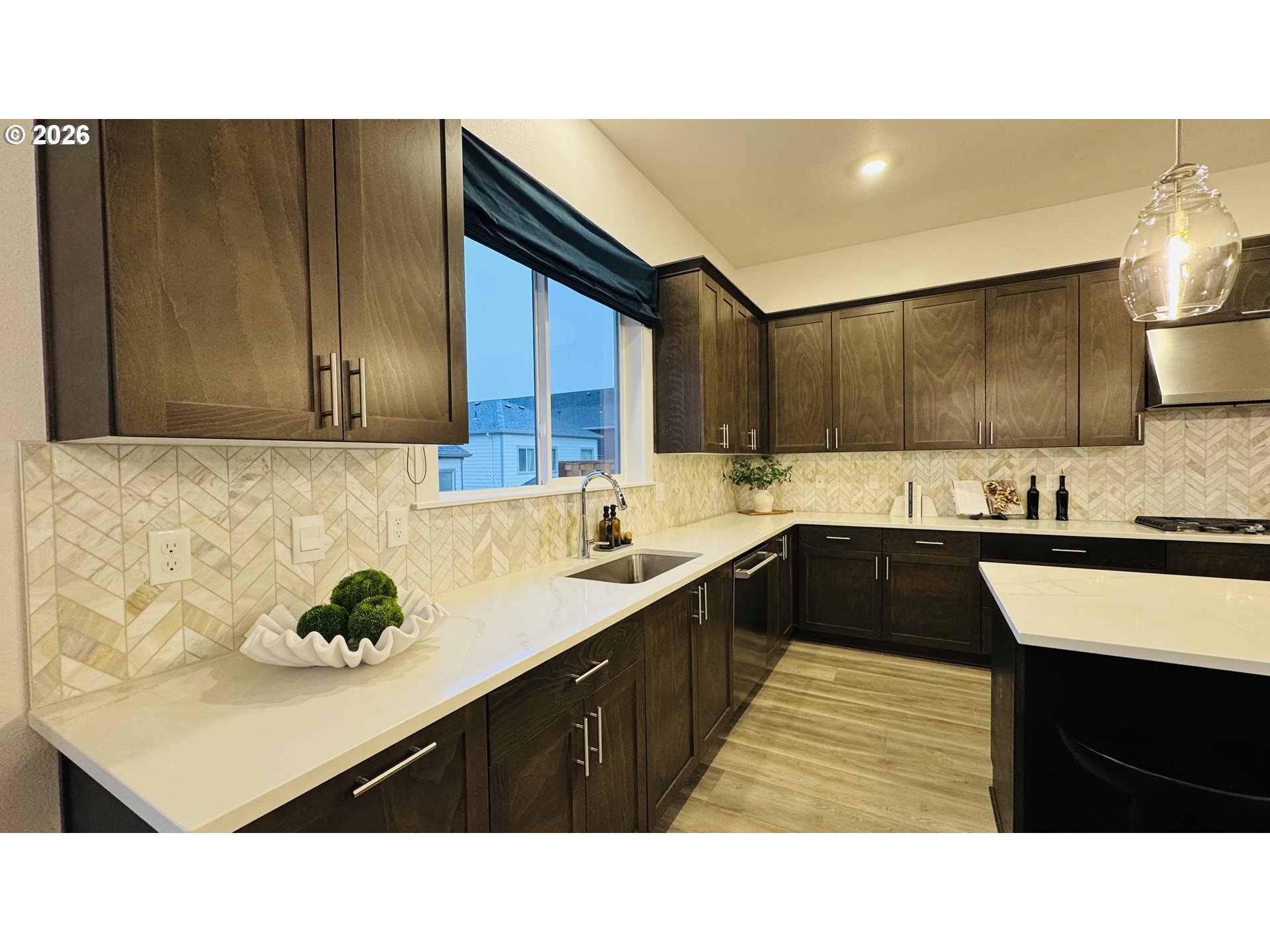 11651 Southwest Hayrick Terrace Beaverton, OR 97007 - Photo 17 of 44 a kitchen with kitchen island granite countertop a sink window and cabinets