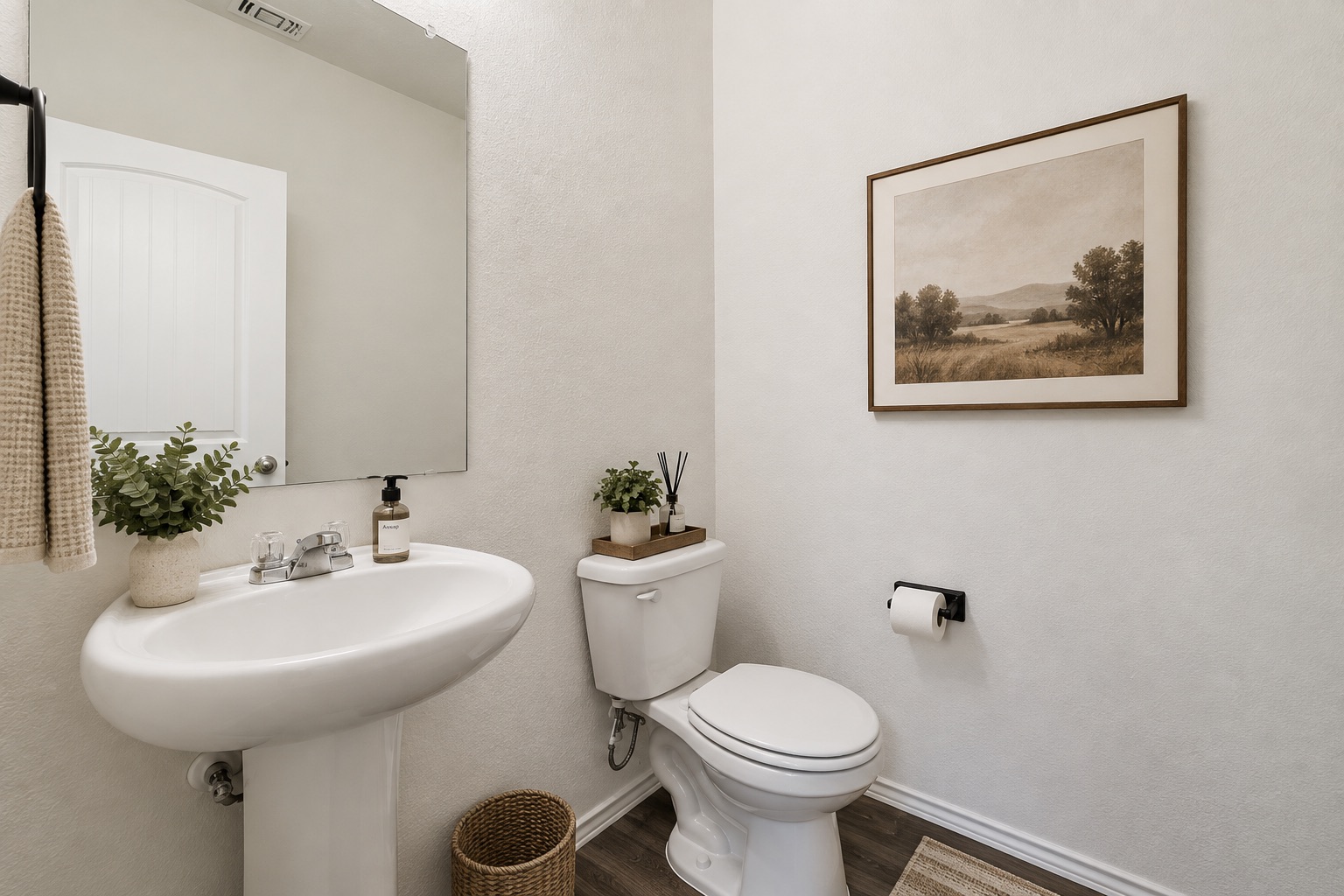 15011 Tuff Rd Manor Manor, TX 78653 - Photo 17 of 37 Virtually staged half bathroom with a pedestal sink, wall mirror, and wood-look flooring, conveniently located for guests.