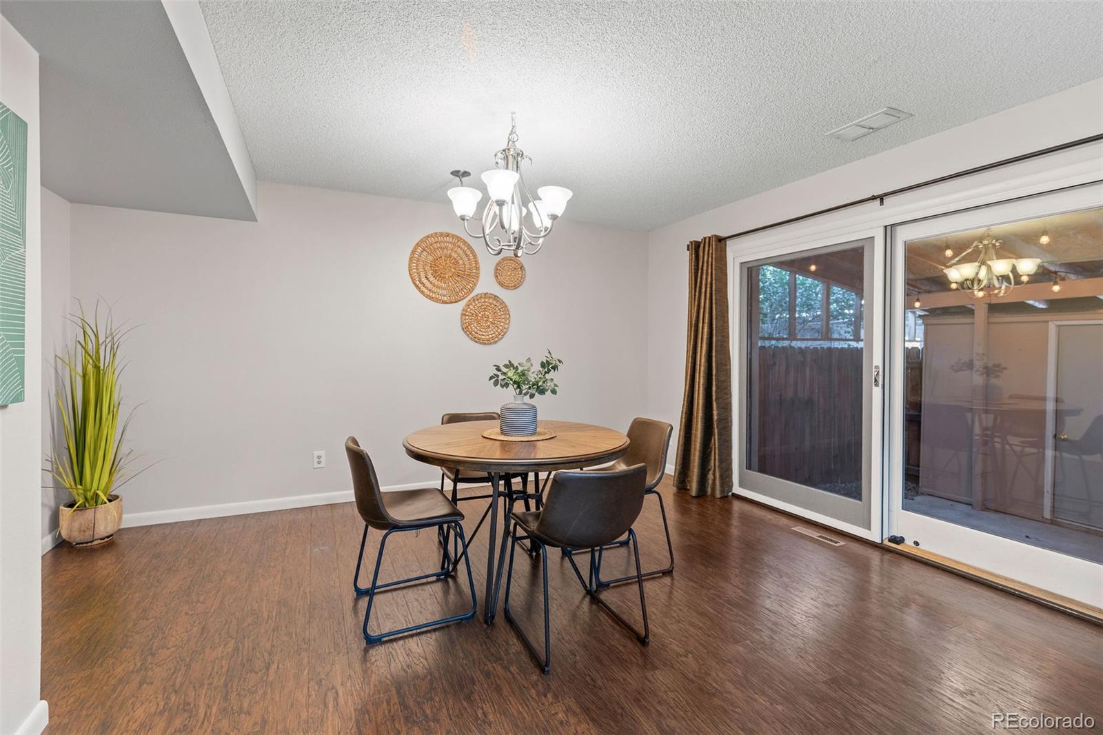 9149 Mansfield Avenue, Unit L Denver, CO 80237 - Photo 12 of 35 a view of a dining room with furniture and chandelier