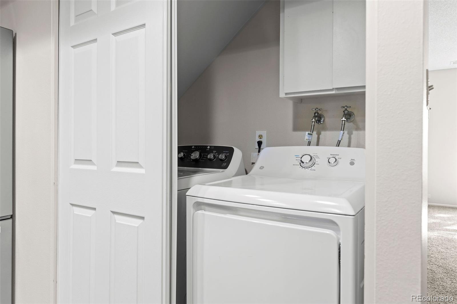 9149 Mansfield Avenue, Unit L Denver, CO 80237 - Photo 18 of 35 a utility room with dryer and washer