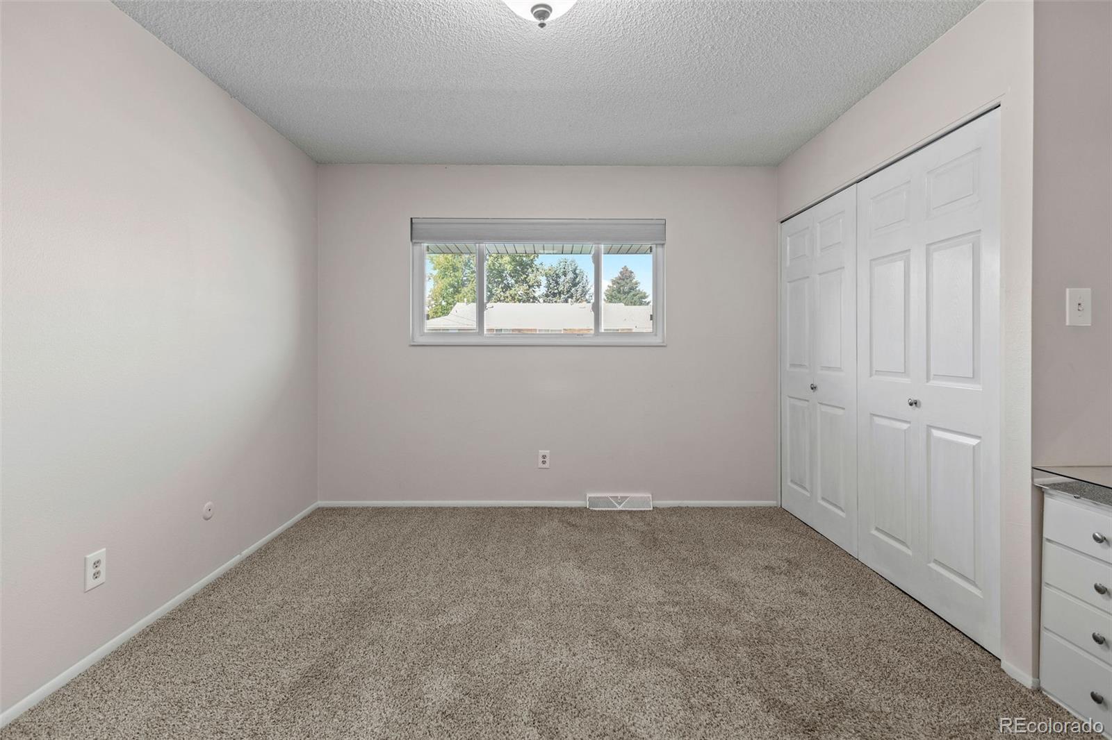 9149 Mansfield Avenue, Unit L Denver, CO 80237 - Photo 20 of 35 an empty room with a window