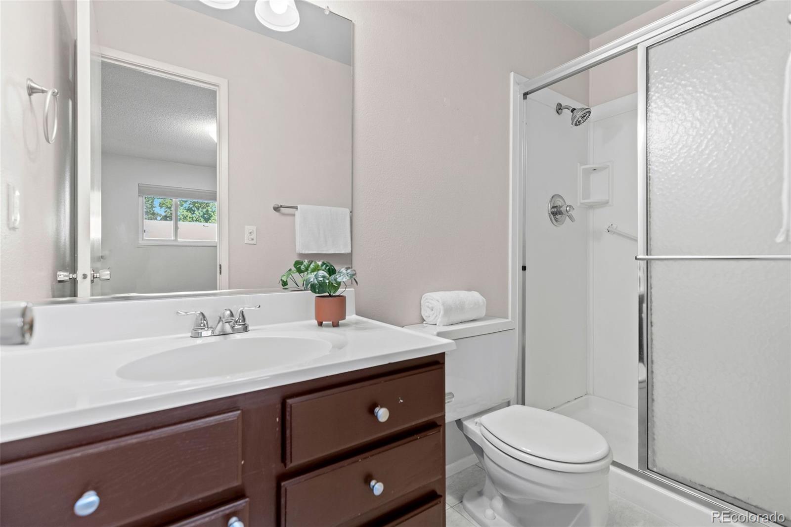 9149 Mansfield Avenue, Unit L Denver, CO 80237 - Photo 22 of 35 a bathroom with a sink toilet and shower