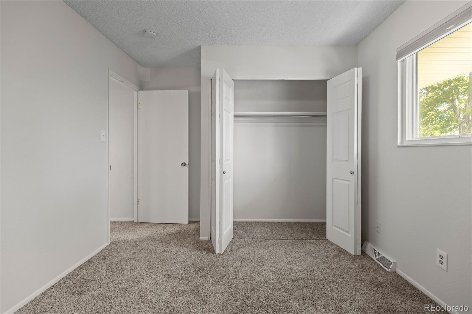 9149 Mansfield Avenue, Unit L Denver, CO 80237 - Photo 26 of 35 a view of an empty room with a closet