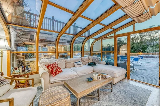 a living room with furniture and a floor to ceiling window