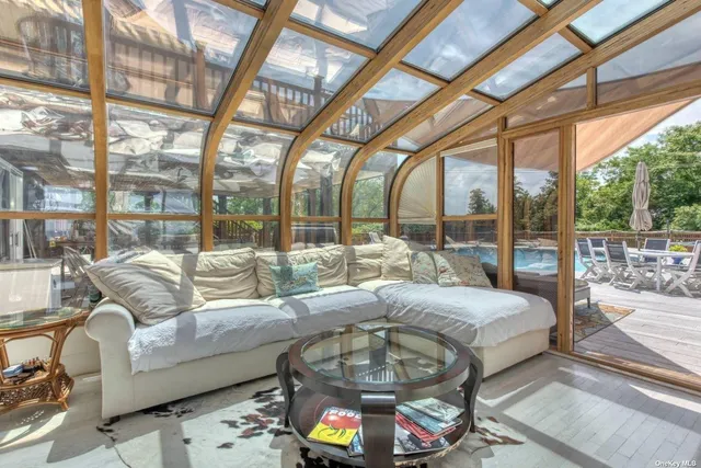 a living room with furniture and a floor to ceiling windows