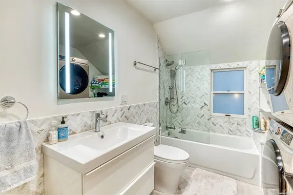 a bathroom with a sink toilet bathtub and vanity