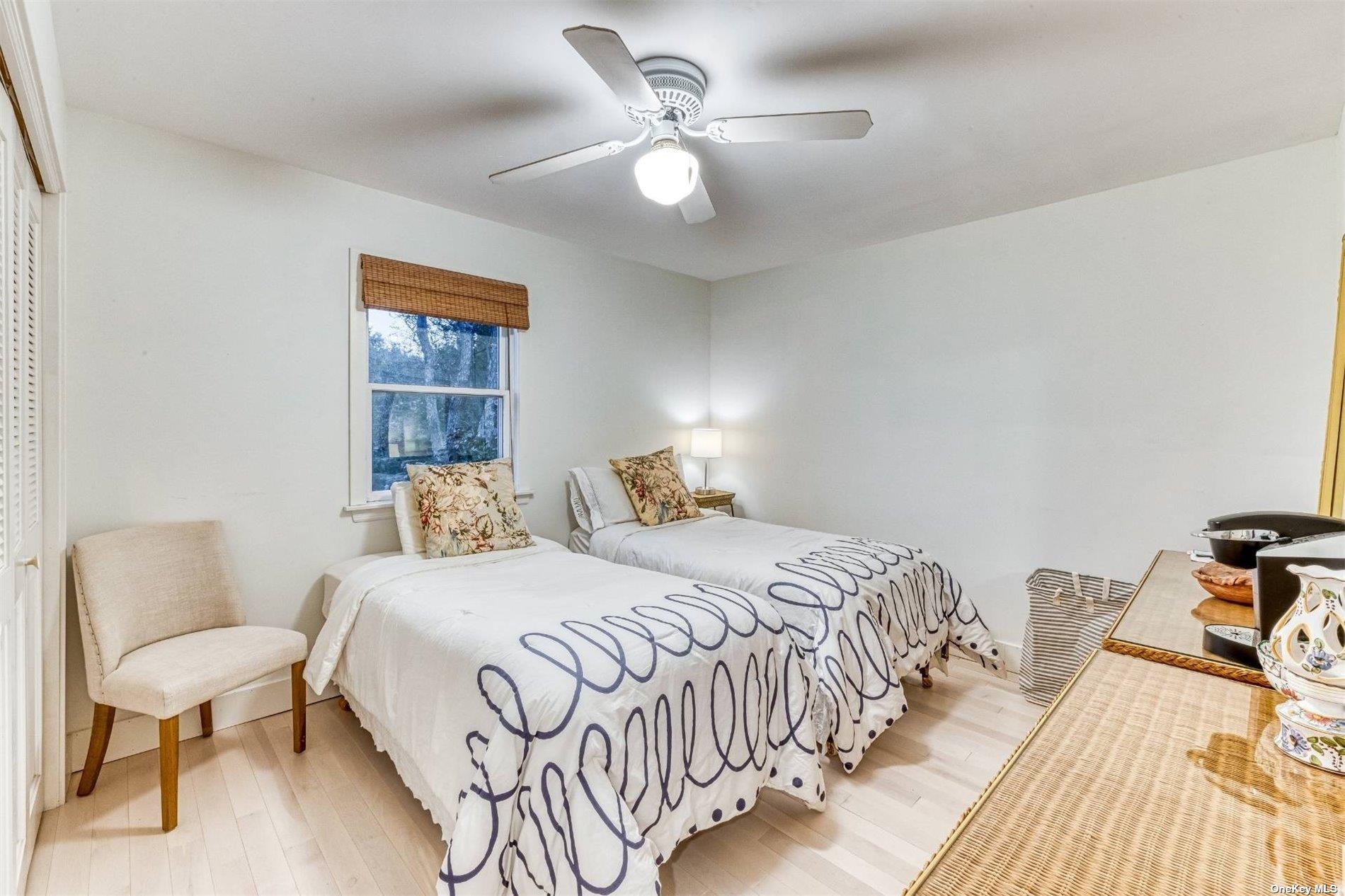 2430 Dignans Road Cutchogue, NY 11935 - Photo 17 of 26 a bedroom with a bed and a table