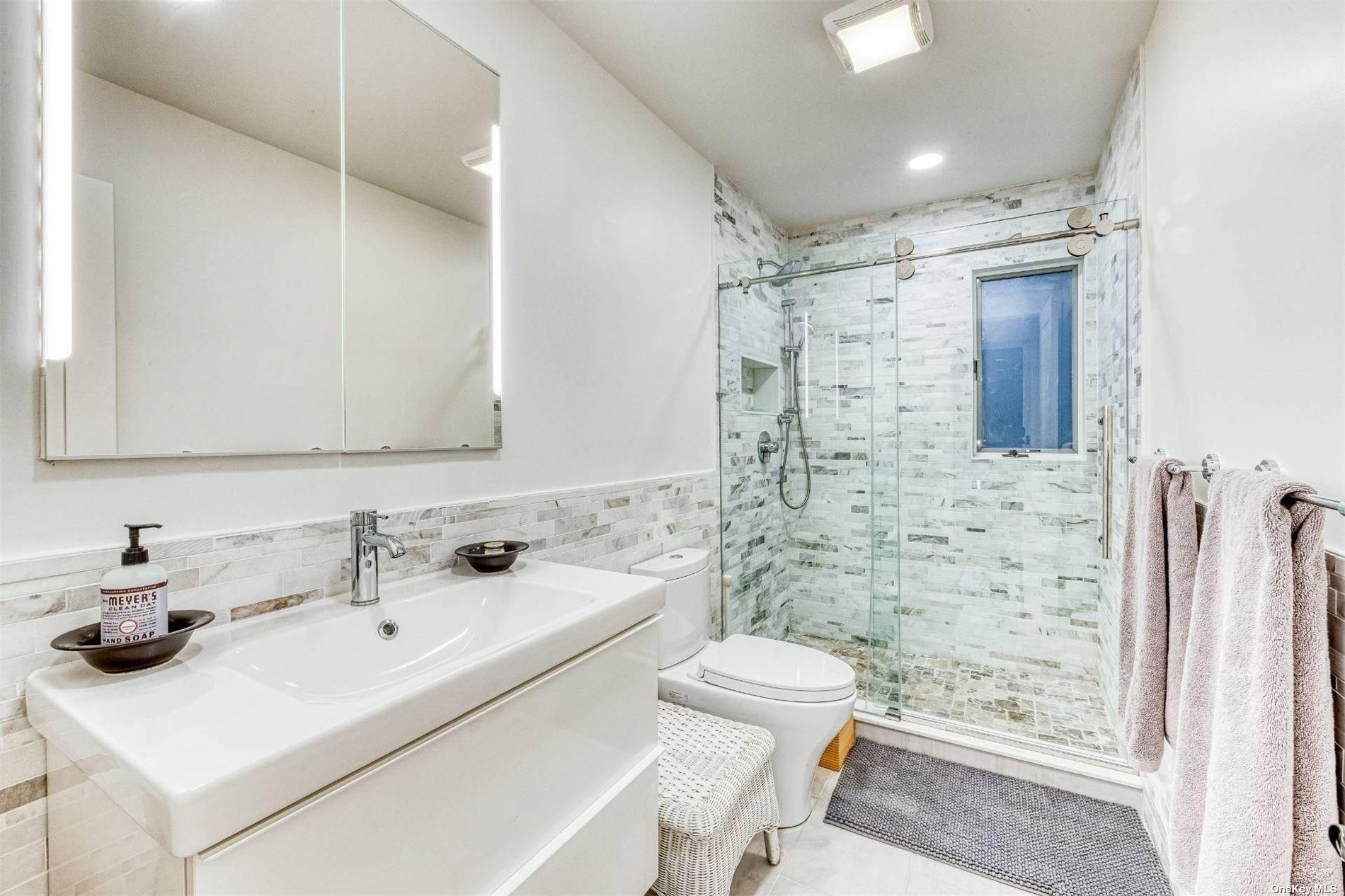 2430 Dignans Road Cutchogue, NY 11935 - Photo 18 of 26 a bathroom with a sink toilet and shower