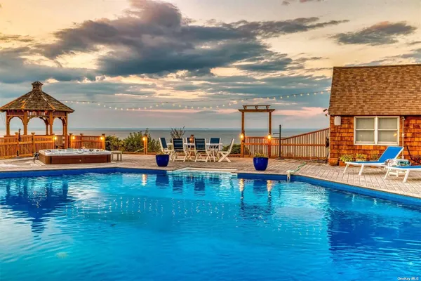 a view of a swimming pool with a table and chairs