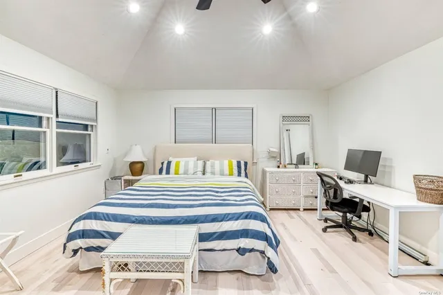 a bedroom with a bed and a large window