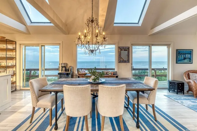 a dining room with furniture a chandelier and wooden floor