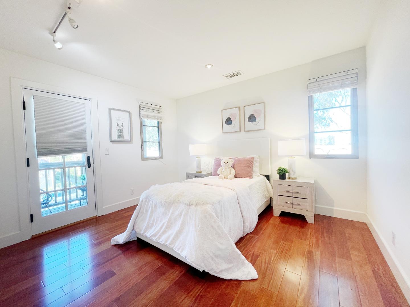 1325 Dahlia Loop San Jose, CA 95126 - Photo 15 of 31 a bedroom with a bed and wooden floor