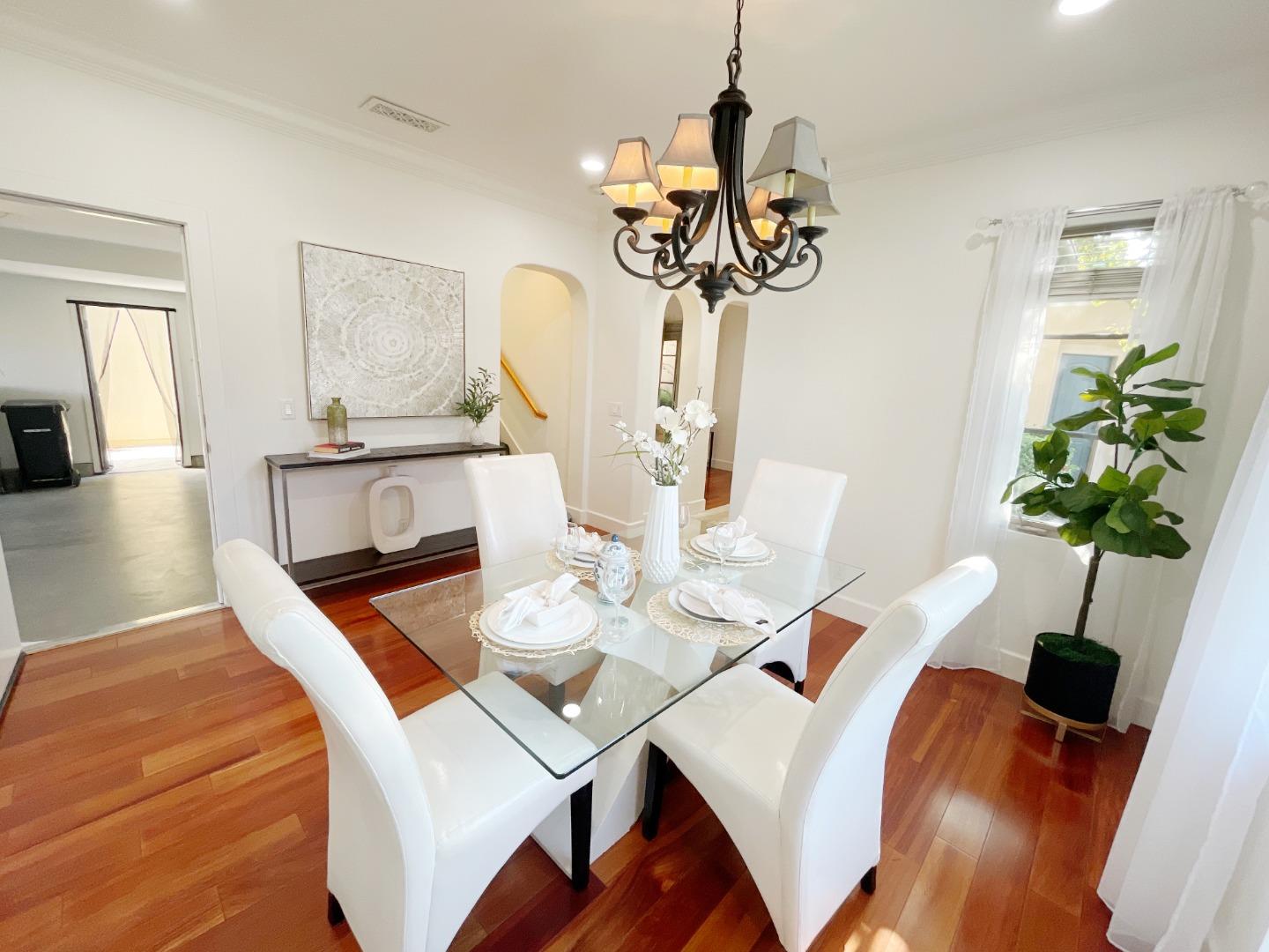 1325 Dahlia Loop San Jose, CA 95126 - Photo 5 of 31 a view of a dining room with furniture wooden floor and chandelier