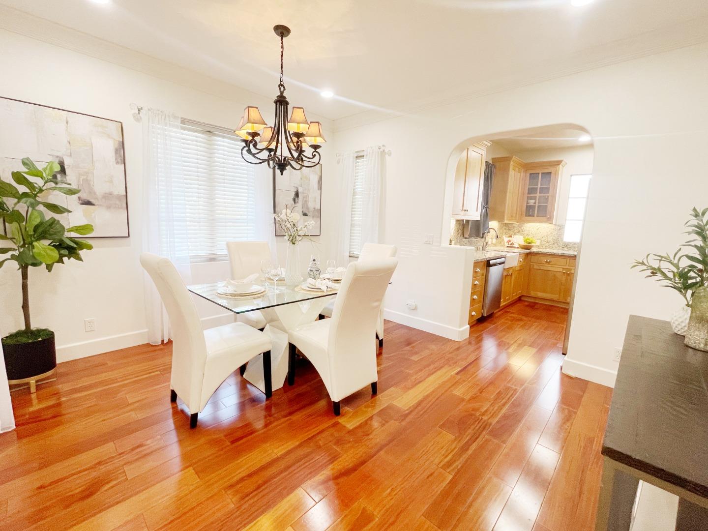 1325 Dahlia Loop San Jose, CA 95126 - Photo 7 of 31 a view of a dining room with furniture wooden floor and chandelier