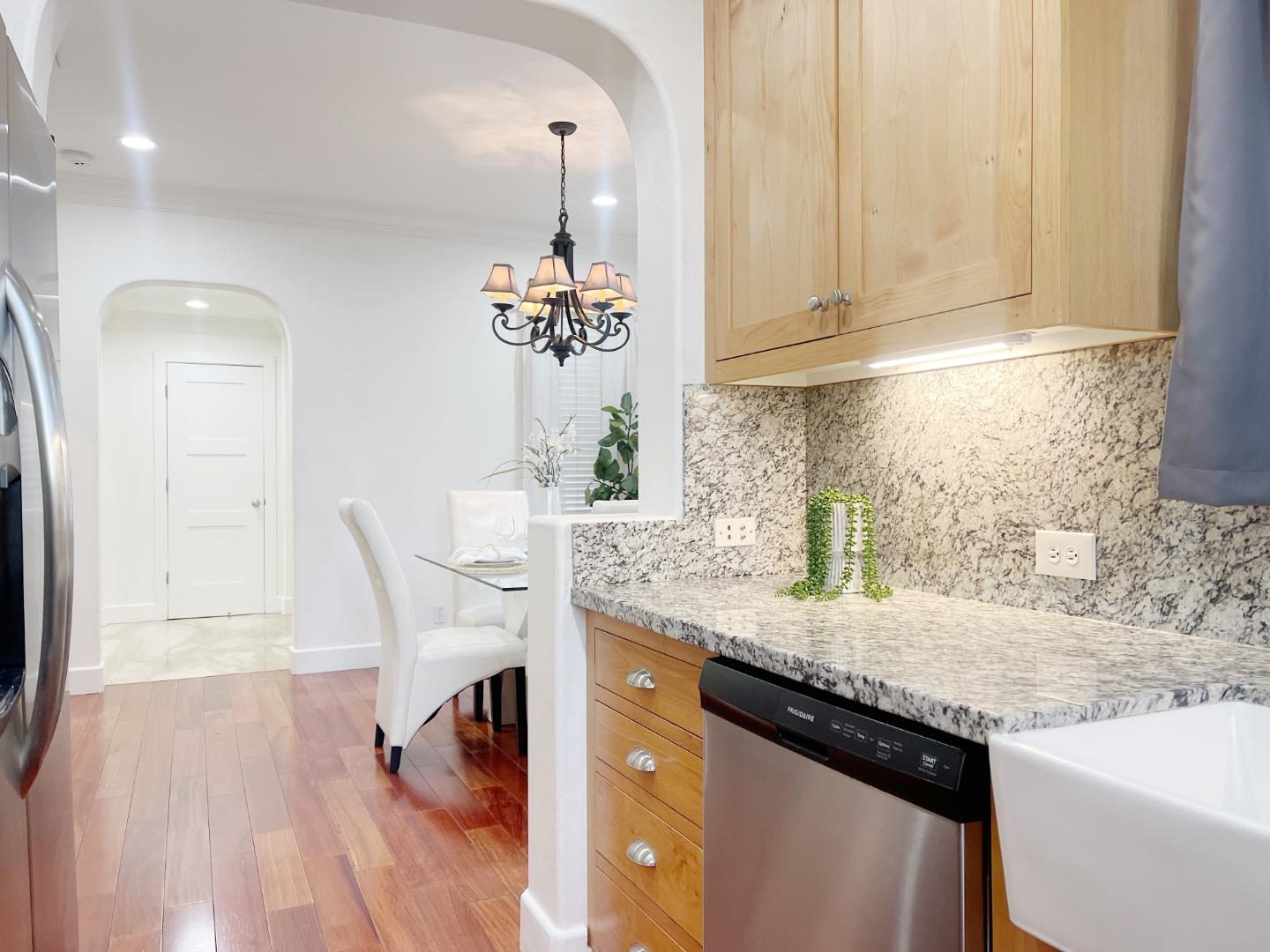 1325 Dahlia Loop San Jose, CA 95126 - Photo 8 of 31 a kitchen with granite countertop white cabinets and a sink