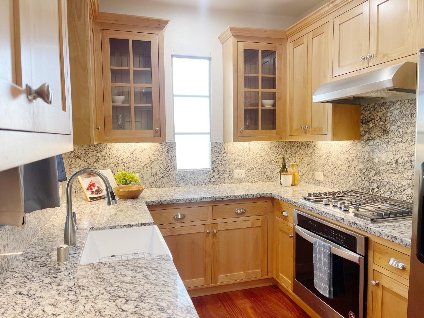 1325 Dahlia Loop San Jose, CA 95126 - Photo 10 of 31 a kitchen with granite countertop a sink a stove and cabinets